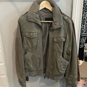 Look like leather.  Military color.  Classic bomber jacket.  Stylish. No stains.